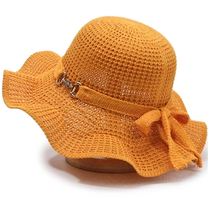 Orange knitted sun hat for women with wide wavy brim and elegant bow metal buckle detail