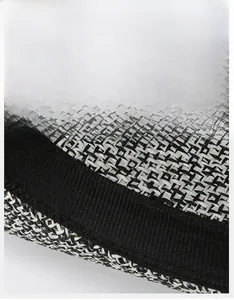 Detail view of woven straw hat featuring wide black moisture-wicking inner sweatband