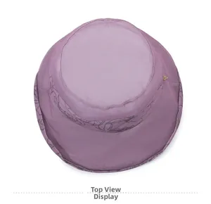 Top view of purple sun hat with delicate line-drawn floral pattern on the brim