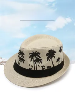 Detail of breathable beige straw fedora with palm tree print and black ribbon band