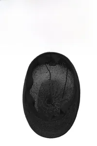 Close-up of internal wash label showing 100% paper material for breathable straw cap
