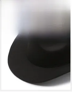 Detail of a wide flat brim black wool felt fedora showing its thick texture and firm shape