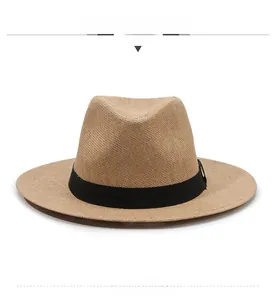 Front view of a classic brown woven straw fedora hat with a black ribbon band detail