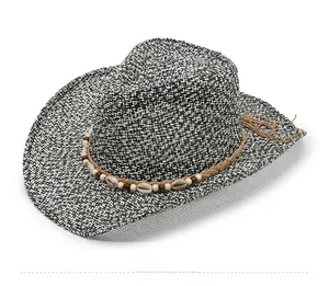 Detail of woven straw cowboy hat featuring shell accents and brown beaded rope band