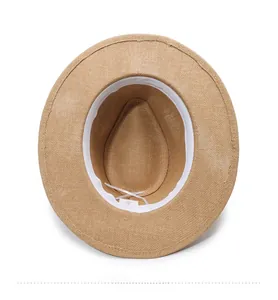 Detailed interior of straw hat with white sweatband and adjustable drawstring