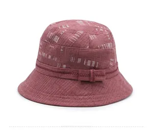 Dettaglio cappello parasole rosso in cotone e lino con motivo geometrico e fiocco