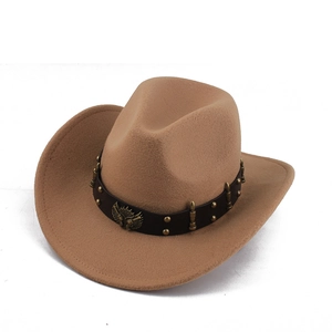 Detailed macro of western cowboy hat featuring metal eagle crest and decorative rivets