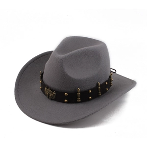 Macro detail of a grey cowboy hat featuring a black leather band with an eagle metal emblem