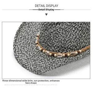 Detail of wide brim straw hat with seashell and wooden bead decorative brown band