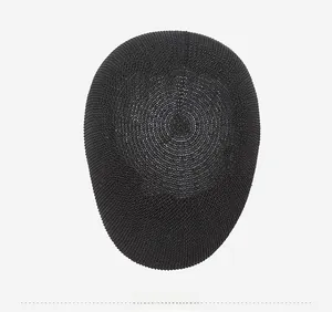 Top down macro view of the black breathable mesh fabric texture on the summer beret hat