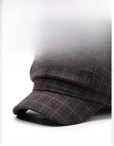 Detailed close-up showing the structured brim and plaid wool texture of the retro newsboy cap