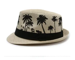 Detail of beige straw fedora with black palm tree embroidery and ribbon trim