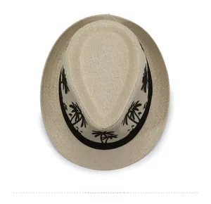 Top view of cream woven fedora hat with black palm tree embroidery on the ribbon