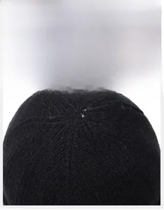 Detail of the multi-panel stitching and ribbed knit texture on a black winter beanie hat