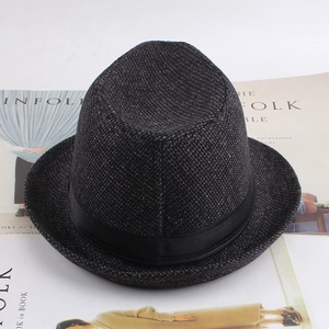 Detail of grey plaid fedora hat with black satin band on a minimalist magazine background