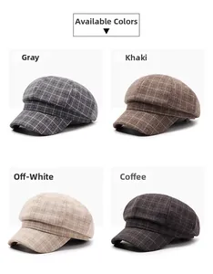 Detail view of plaid newsboy hats in grey, khaki, off-white, and coffee brown colors