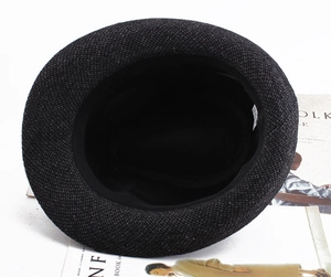 Detail view of the thick wool blend inner lining and sweatband of a grey plaid fedora hat