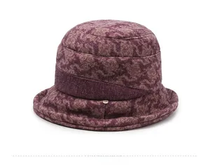 Detail view of the deep purple textured fabric and bow decoration on this elegant cloche hat