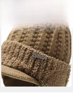 Detailed view of the waffle knit texture and metal rhinestone accent on the winter hat