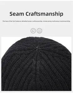 Close-up of the fine stitching and top seam construction on a black knitted beanie
