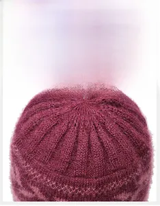 Detail of radial stitching on a burgundy knitted hat showing high-quality craftsmanship