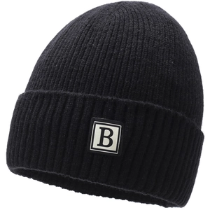 Detail of ribbed knit winter beanie featuring a square black B letter patch and cuffed brim