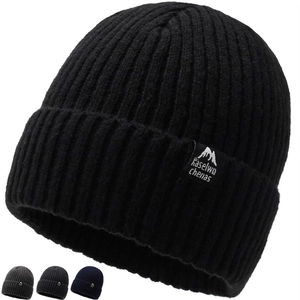 Black ribbed knit beanie with mountain logo tag and multi-color swatches in studio view