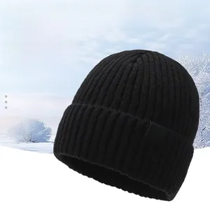Detailed close-up of a black knitted beanie with warm fleece lining for winter insulation
