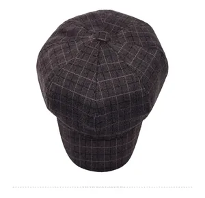 Top view of a brown plaid newsboy cap with vintage wool texture and button detail