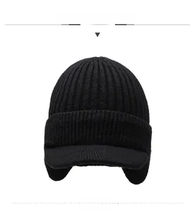 Detail of black winter knit hat featuring warm earflaps and a sport embroidery design