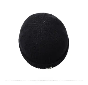 Detailed top view of black ribbed knit beanie with rectangular R-letter logo patch