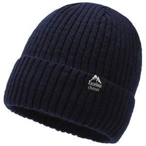 Navy blue ribbed knit beanie with mountain logo tag for winter outdoor warmth