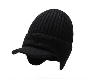 Detail of black knitted beanie with sport embroidery, ear flaps and fleece lining