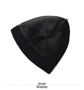 Detail view of the soft fleece lining and ribbed knit texture of a black winter beanie