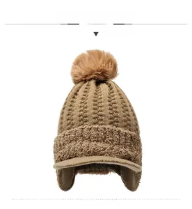 Detailed macro view of camel knitted winter hat with faux fur trim and silver rhinestone