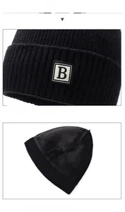 Detail of black rib-knit winter beanie featuring B-letter patch and thick fleece lining