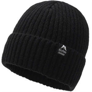 Close-up of black ribbed knit beanie showing thick texture and woven label with mountain logo