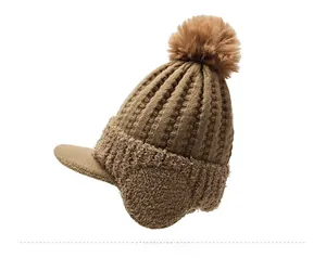 Detailed side view of khaki winter knit trapper hat with pompom and faux fur lining