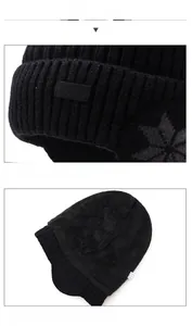 Dettaglio del cappello invernale in maglia nera con morbida fodera in pile termico