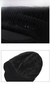 Detail view of black knit winter hat showing thick warm lining and sport embroidery