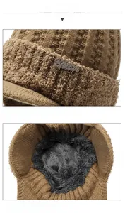 Detail of warm winter knit hat with thick plush lining and crystal letter decoration