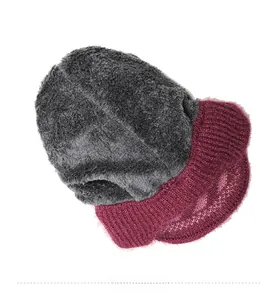 Detail view of winter knitted hat showing double-layer thick grey faux fur lining