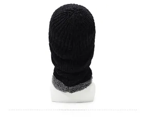 Detail view of the black knitted winter hat with thick grey faux fleece lining on the back