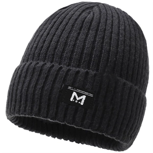 Detail shot showing the thick rib-knit texture and woven patch on the black winter beanie