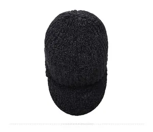 Top down view of black knit winter hat showing thick textured yarn and warm visor detail