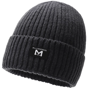 Detail of ribbed knit texture and square fabric logo patch on dark grey beanie