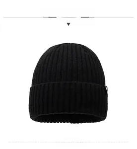 Close-up of black ribbed knit beanie featuring thick folded cuff and side logo detail