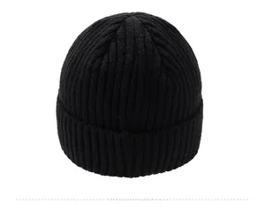 Detail view of the black ribbed knit beanie showing thick texture and warm yarn quality