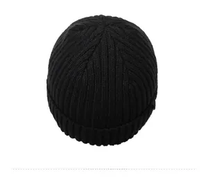 Top view of black ribbed knit beanie showing thick texture and folded cuff detail