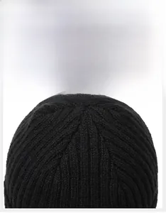 Close-up of top stitching and ribbed texture on the black knitted winter beanie